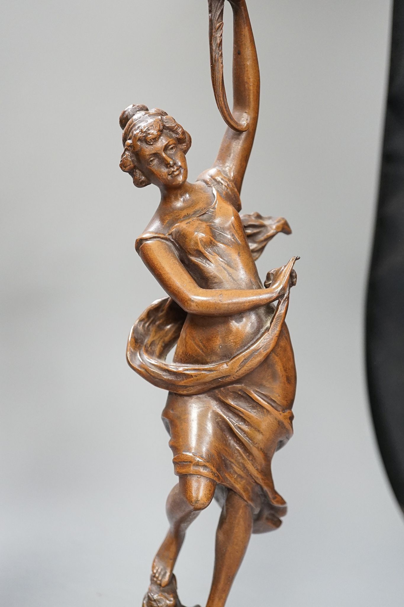 A pair of bronze female dancers, on marble plinths, 47cm